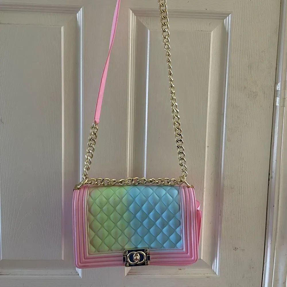 Jelly quilted pink rainbow flop crossbody bag with gold tone chain accen…
